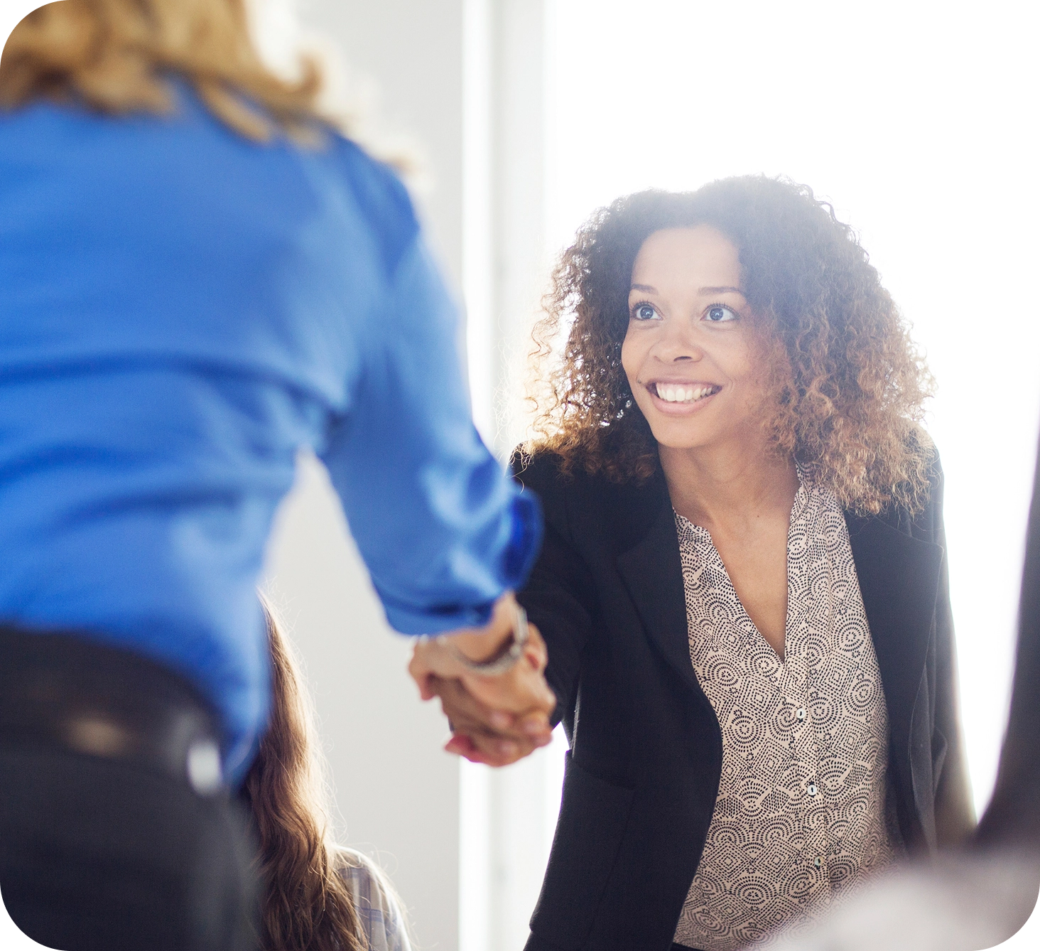 Two financial advisors shaking hands
