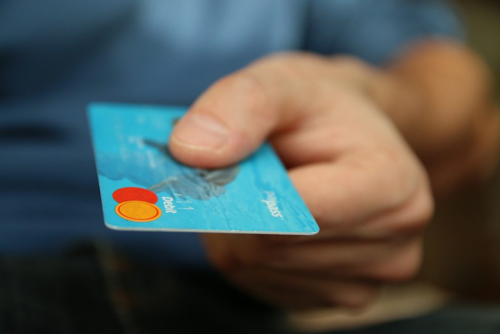 An image of a close-up of a person holding a credit card. Keeping Cool as UK credit card market overheats