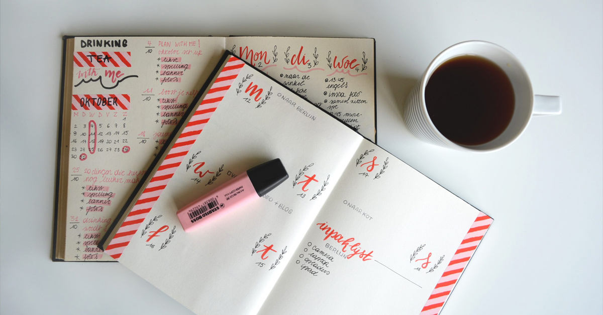 An image of two bullet journals that are decorated and well kept. A cup of tea and a pink highlighter are also visible in the photo. Bullet journal: Getting creative with your finances
