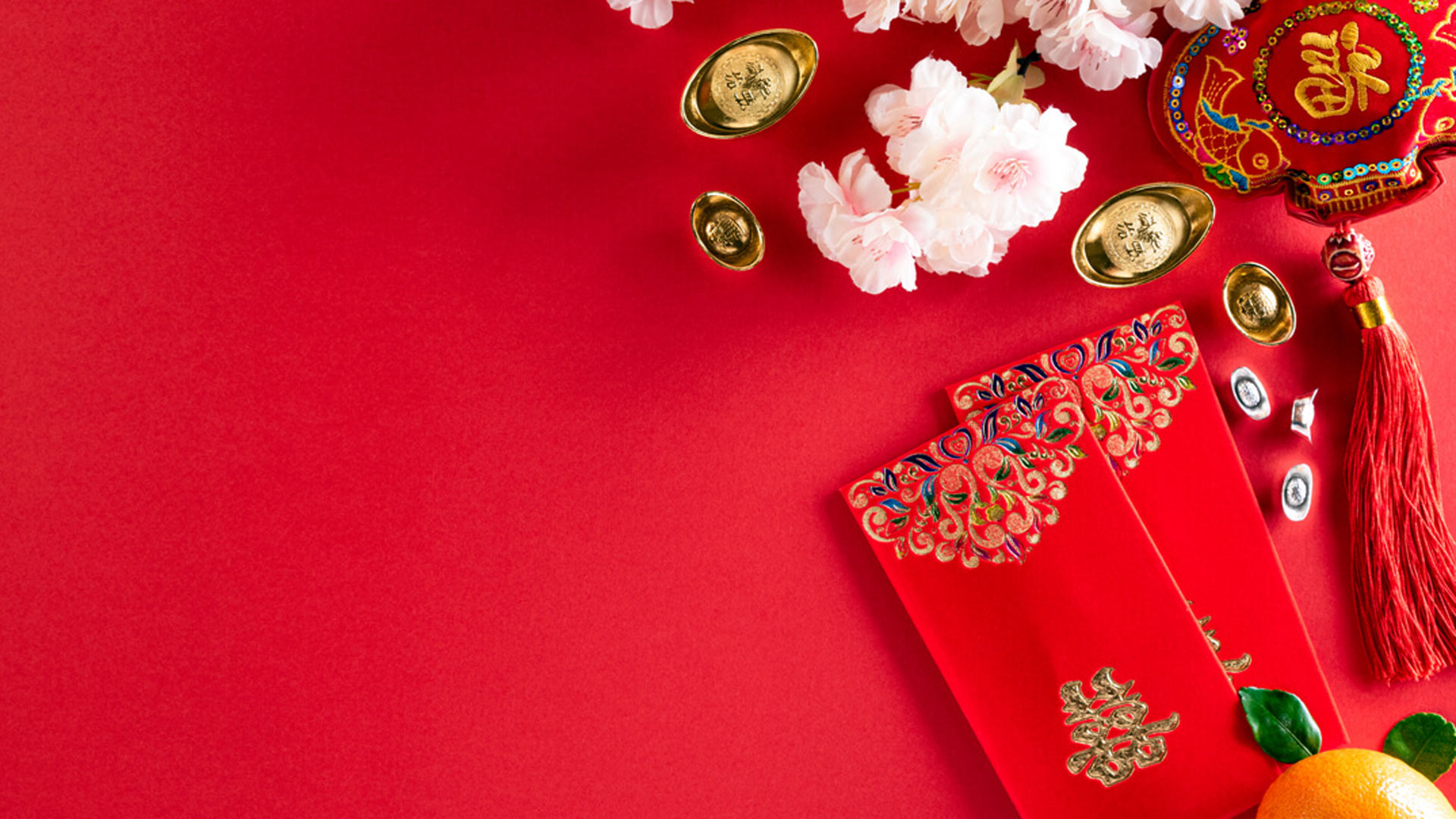An image of Chinese ornaments, an orange and flowers on the red background. Chinese New Year lessons: Portfolio diversification