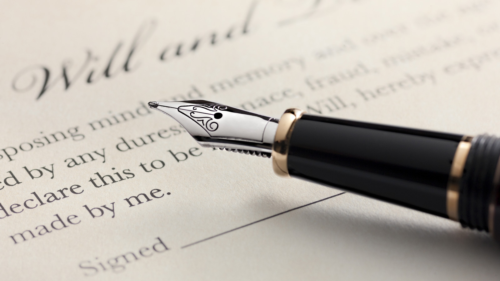 An image of a fountain pen with a will in the background. Will and foreign inheritance laws
