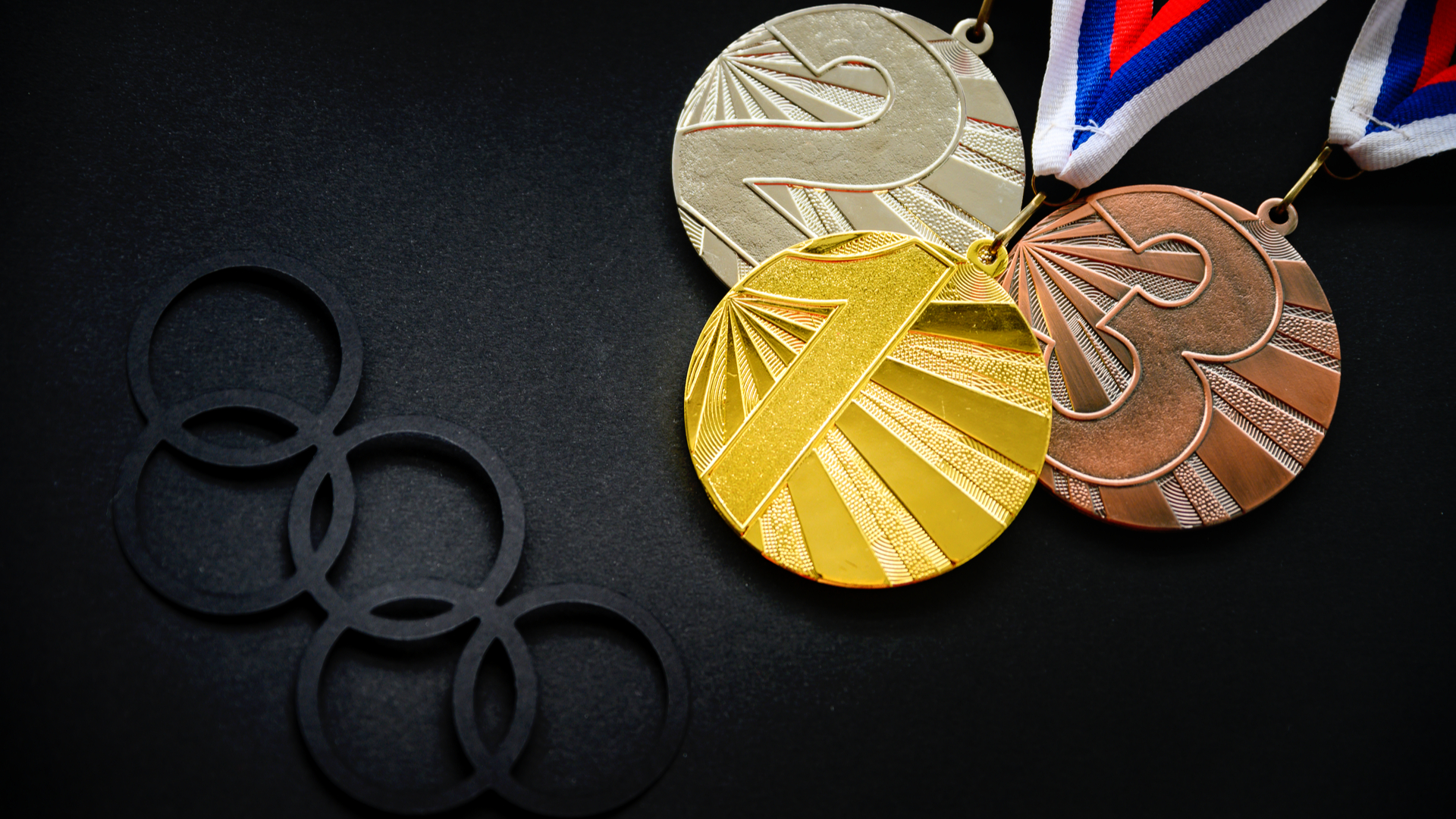 An image of the Olympic coins. Gold from Silver