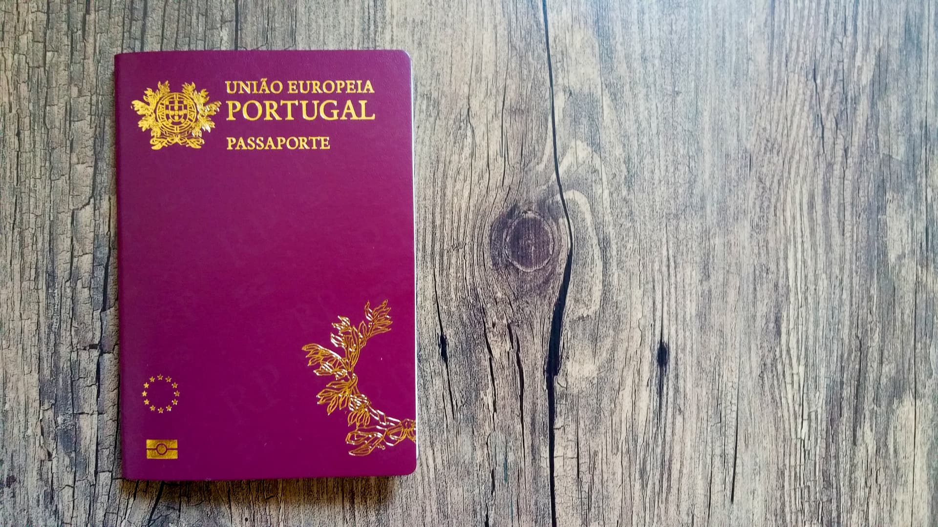 An image of the Portuguese passport on the wooden table. Changes to the Portuguese Golden Visa in 2022